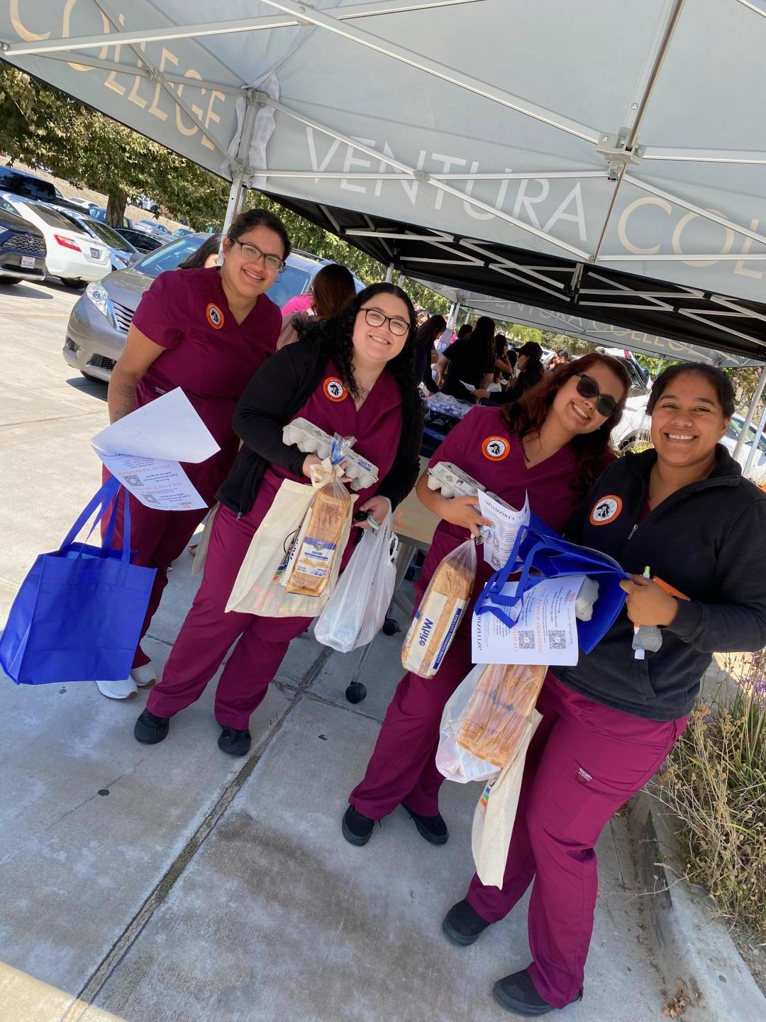 Vet Tech students holding their free groceries